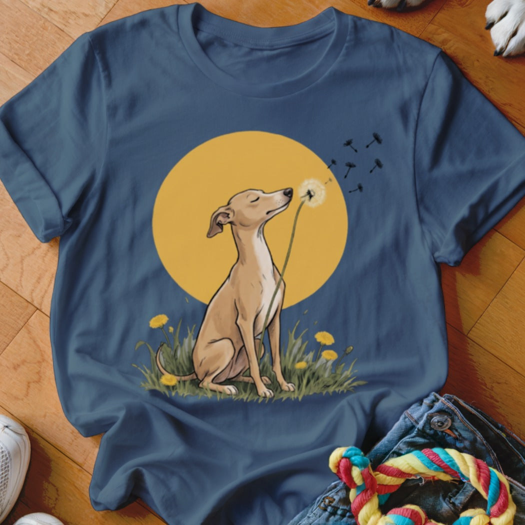 Dark blue t-shirt featuring an illustration of a dog sitting in a field blowing dandelions against a yellow circle.
