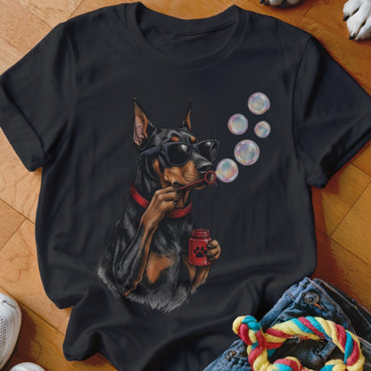 A black t-shirt features a graphic of a Doberman wearing sunglasses and blowing soap bubbles.