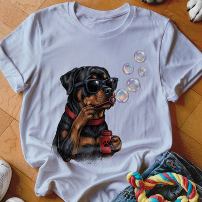 A white t-shirt featuring a graphic of a Rottweiler wearing sunglasses and blowing bubbles.