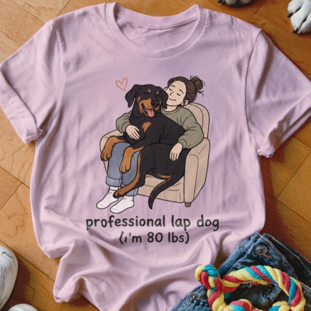Pink t-shirt with cartoon of Rottweiler on woman's lap, text "professional lap dog".