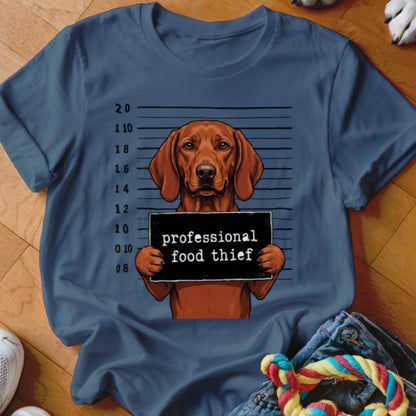 Dog mugshot with text "professional food thief" on a t-shirt.