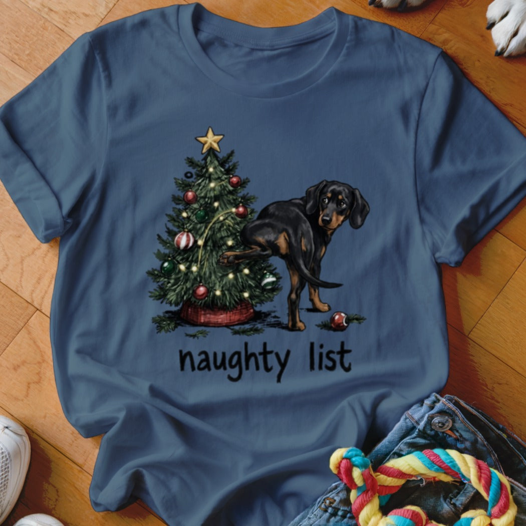 Dachshund at a Christmas tree with "naughty list" text.