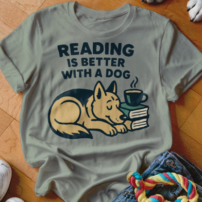 Light green t-shirt with "Reading is Better With A Dog" text and sleeping dog on books.