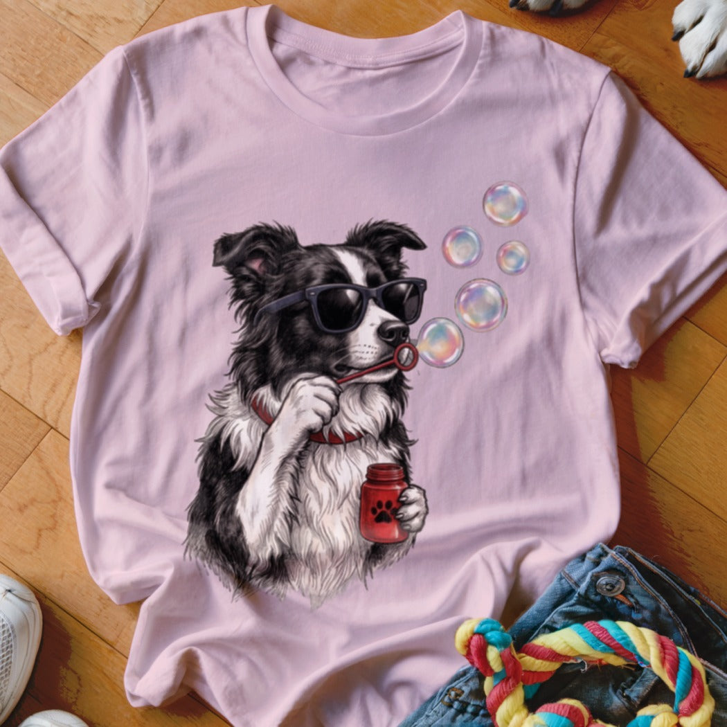 A pink t-shirt features a graphic of a Border Collie wearing sunglasses and blowing bubbles.