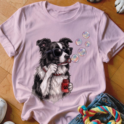 A pink t-shirt features a graphic of a Border Collie wearing sunglasses and blowing bubbles.