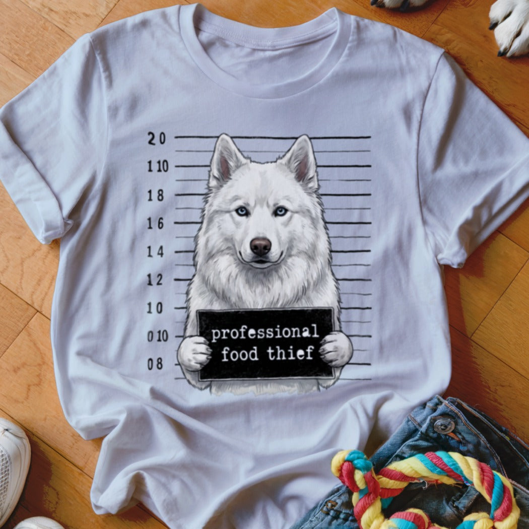 White t-shirt with graphic of a husky in a mugshot holding a sign "professional food thief".