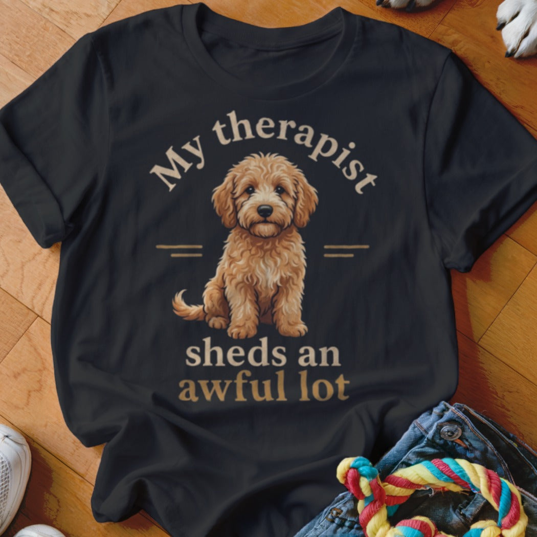 Black t-shirt with a doodle dog and text that reads "My therapist sheds an awful lot".