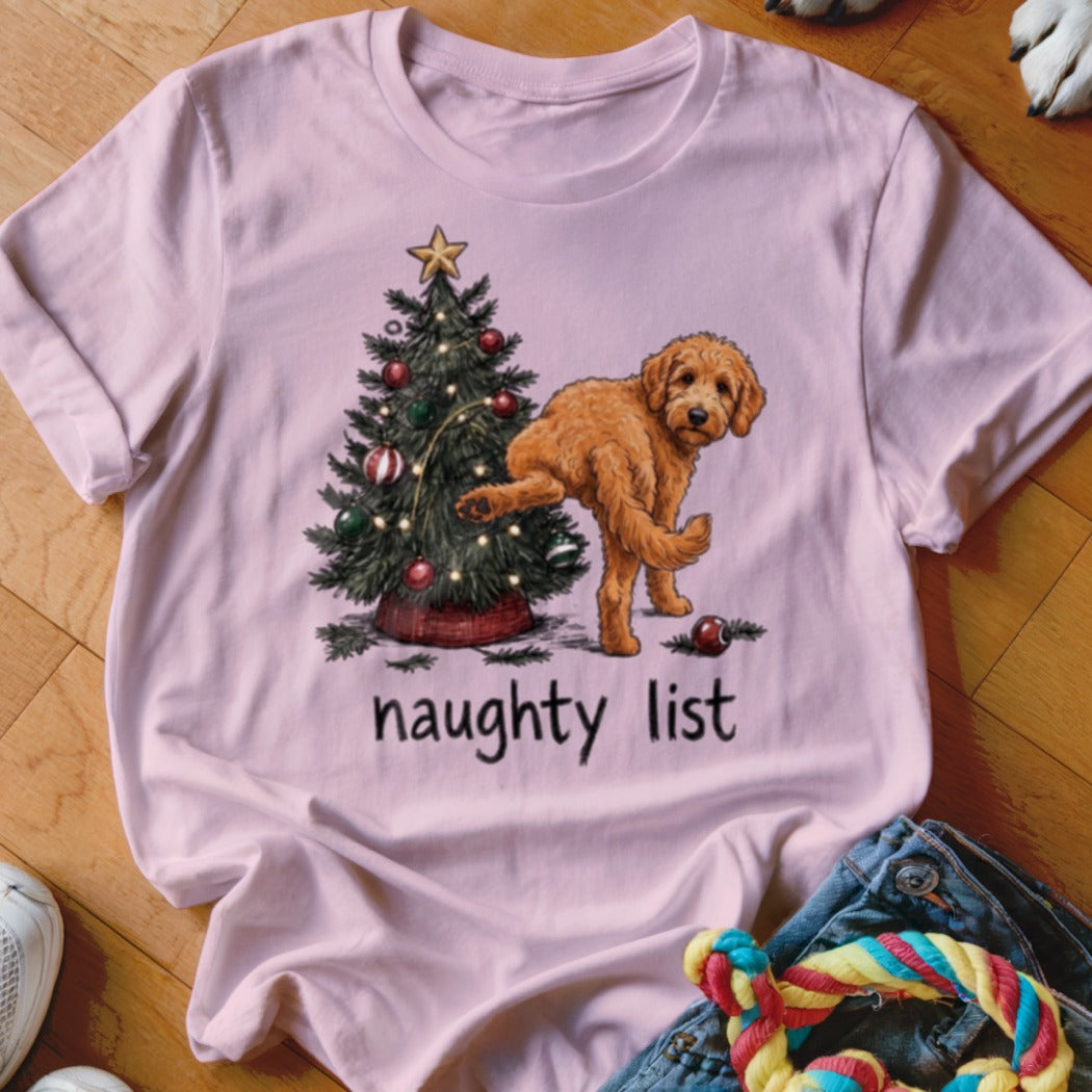 Goldendoodle near Christmas tree with "naughty list" text.