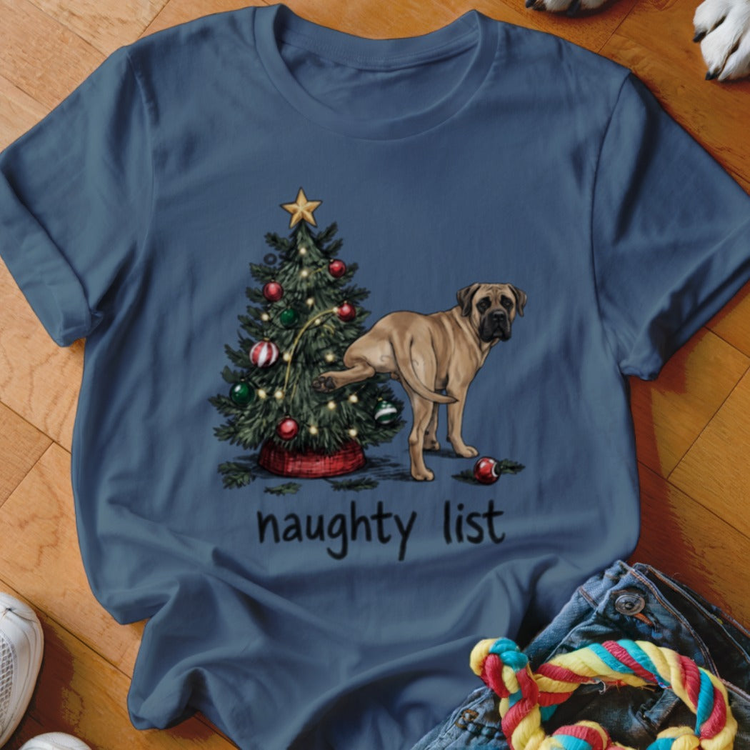 Blue t-shirt featuring an illustration of a dog peeing on a Christmas tree with text reading naughty list.