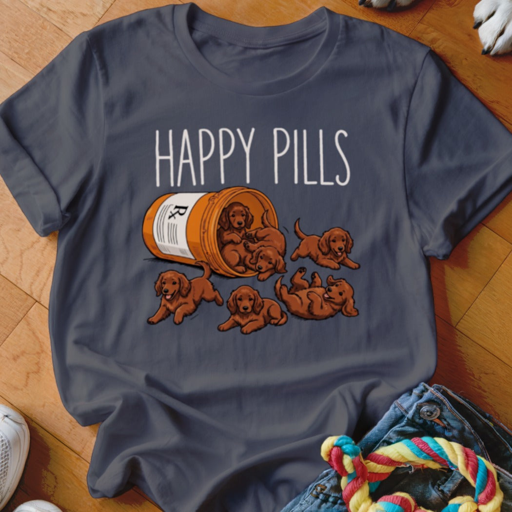 T-shirt graphic: "HAPPY PILLS" text above spilled pill bottle with puppies.