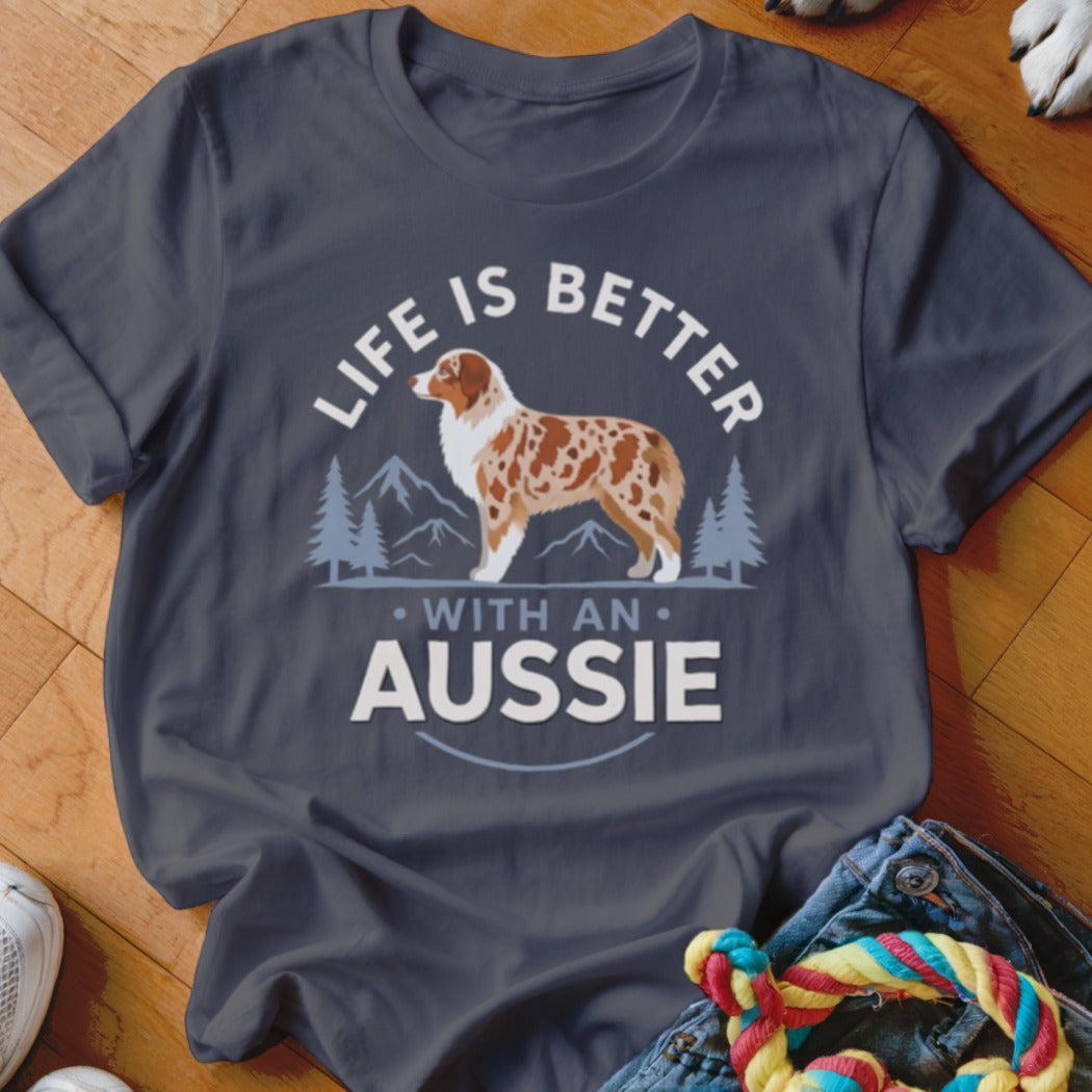 Dark gray t-shirt featuring a graphic of an Australian Shepherd, mountains, and text reading Life Is Better With An Aussie.
