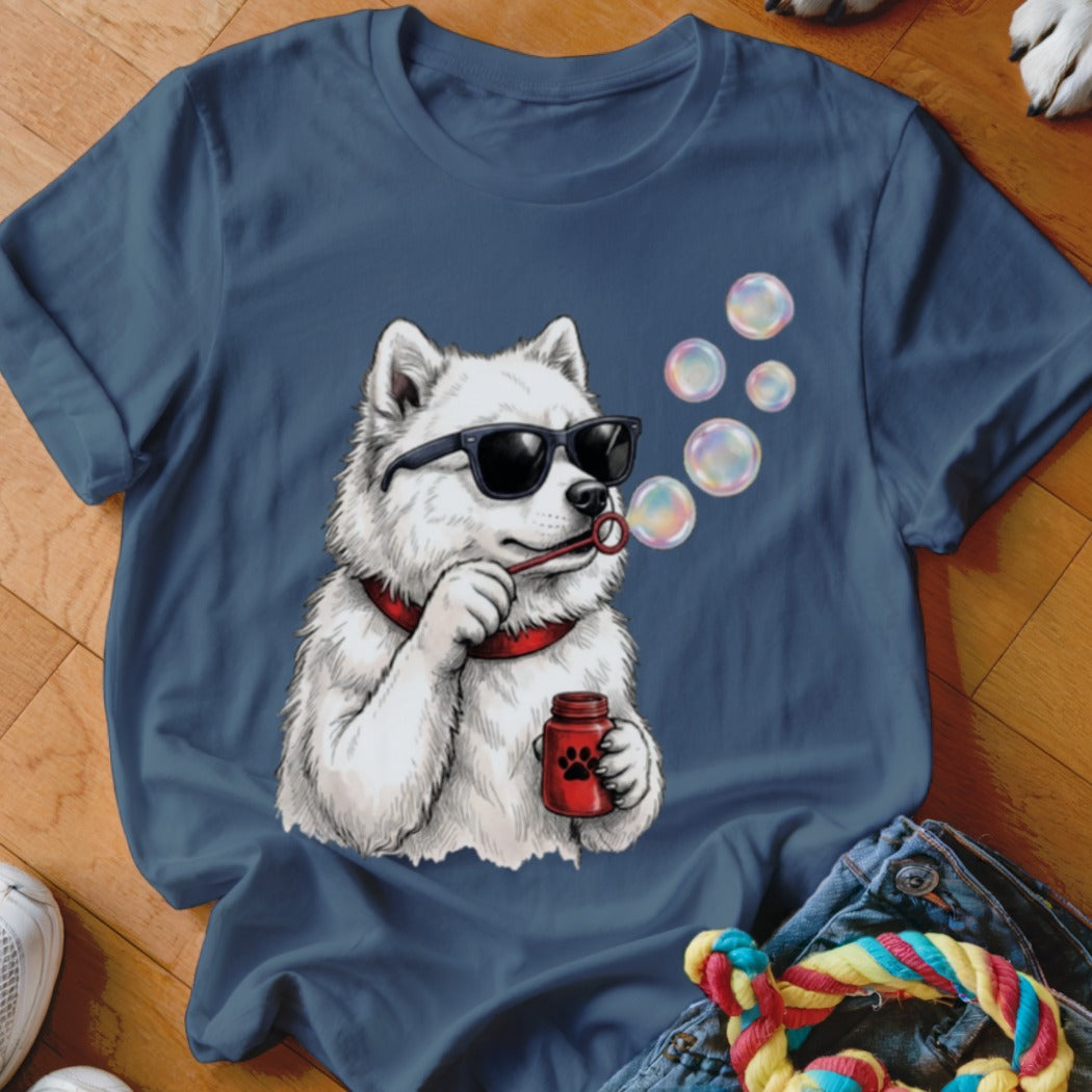 A navy blue t-shirt printed with a graphic of a white dog wearing sunglasses and blowing bubbles.