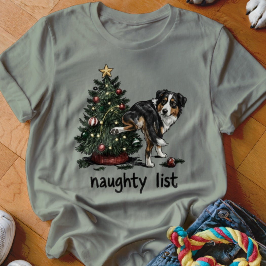 T-shirt with a dog peeing on a Christmas tree and "naughty list" text.
