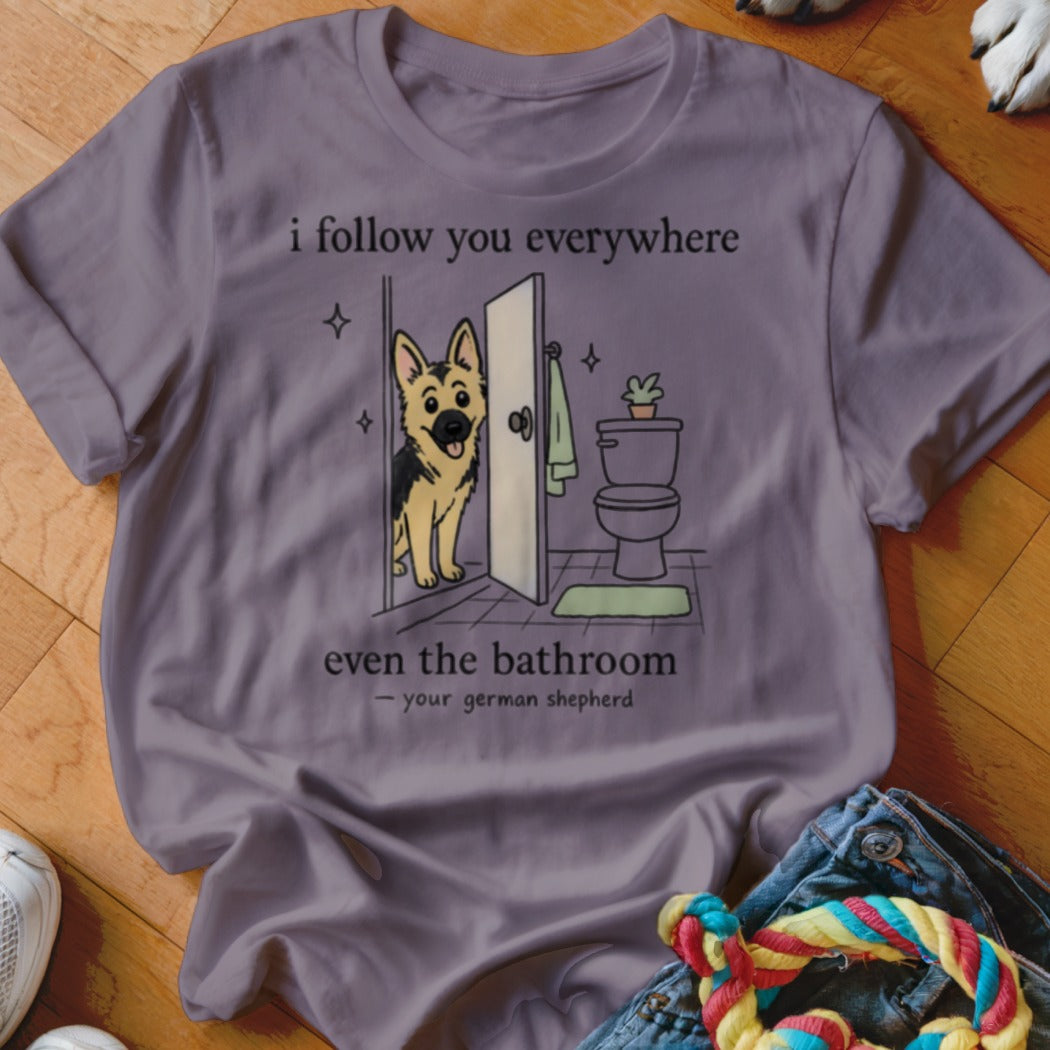T-shirt with cartoon German Shepherd entering a bathroom, saying "I follow you everywhere".