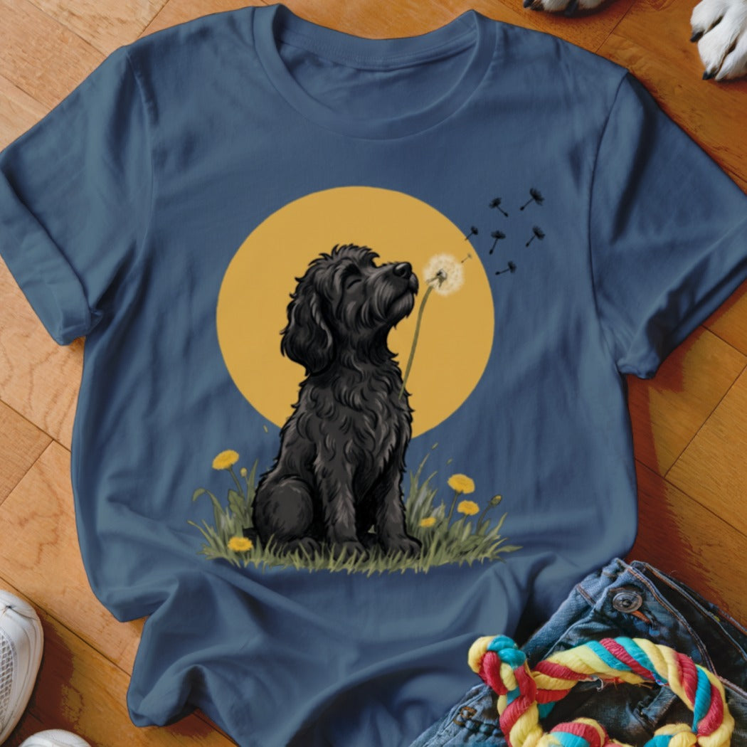 A slate blue t-shirt printed with a black dog sniffing a dandelion against a yellow circle.