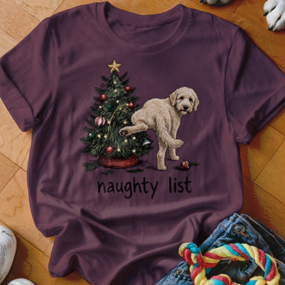 Fluffy dog with raised leg next to Christmas tree, "naughty list" text.