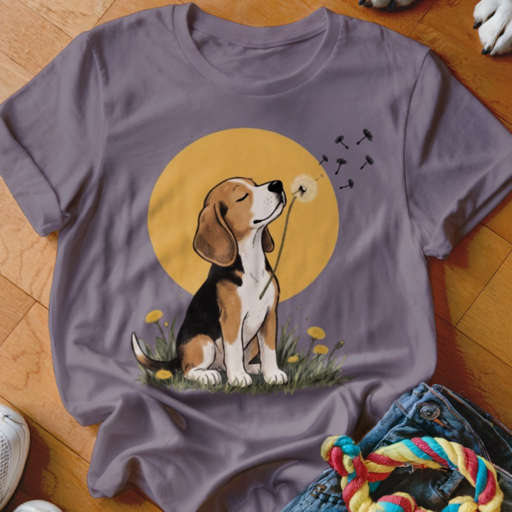 A mauve crewneck t-shirt featuring a graphic of a beagle blowing dandelion seeds against a yellow moon.