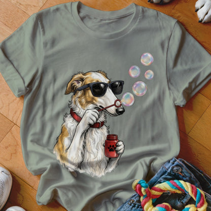 Sage green t-shirt featuring a graphic of a dog wearing sunglasses and blowing soap bubbles.