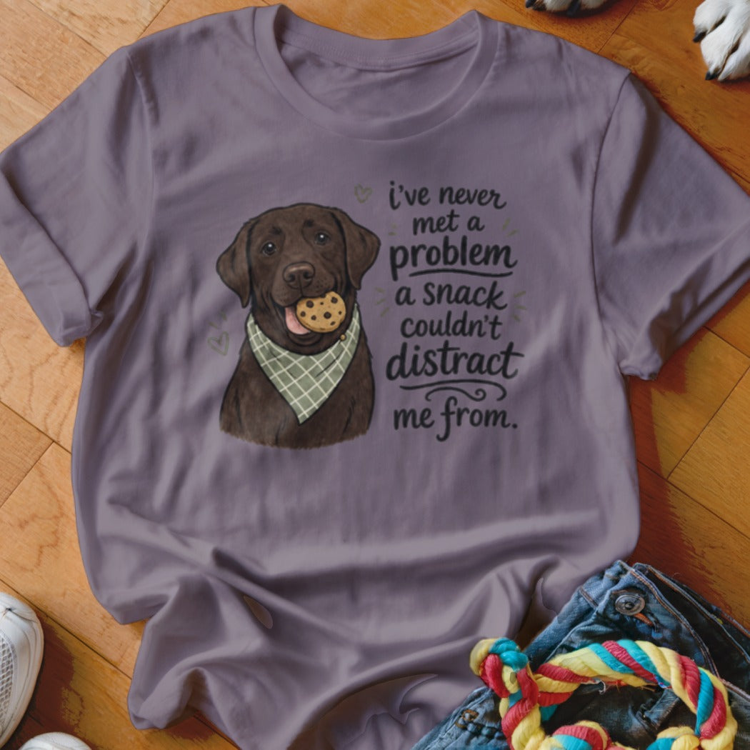 T-shirt with a chocolate lab wearing a bandana and holding a cookie, text reads: "i've never met a problem a snack couldn't distract me from."