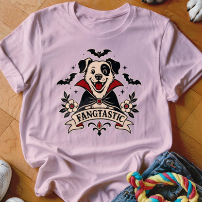 Pink t-shirt with a dog dressed as a vampire and the text "FANGTASTIC".