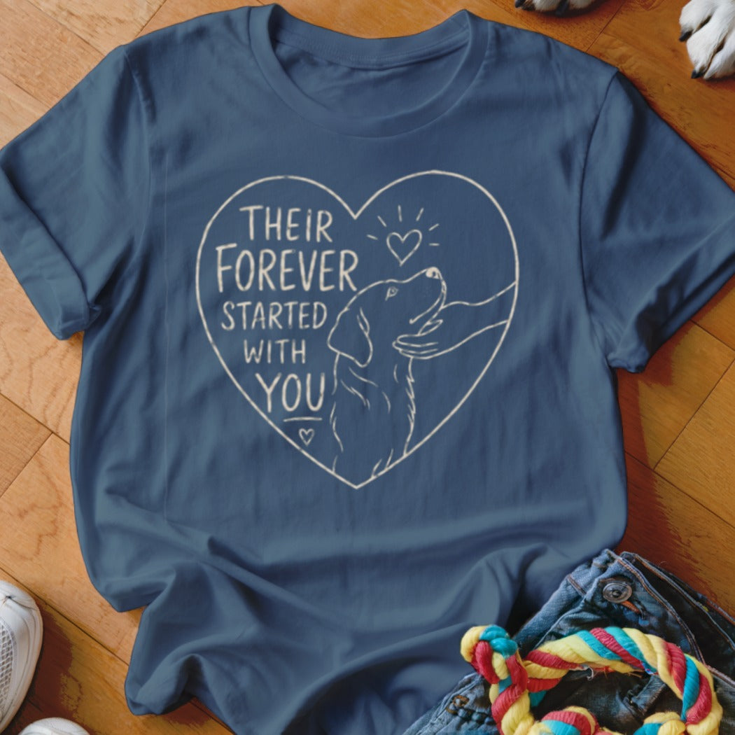 Blue t-shirt with a heart design containing a dog and text "THEIR FOREVER STARTED WITH YOU".