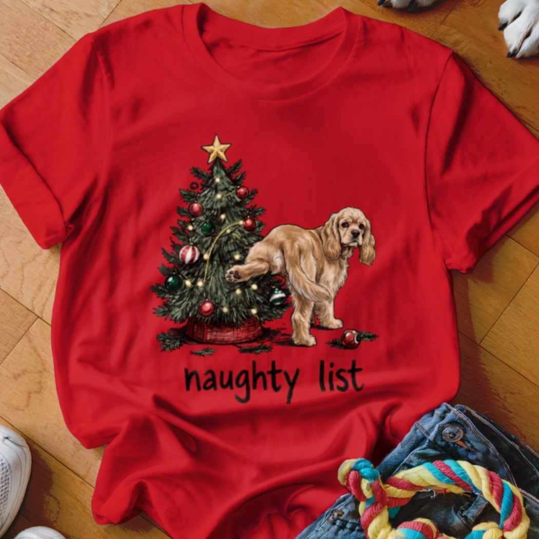 Red t-shirt with a Christmas tree and a dog, featuring text "naughty list".