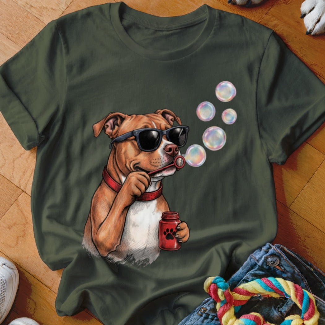 An olive green t-shirt featuring a graphic of a pit bull wearing sunglasses and blowing soap bubbles.