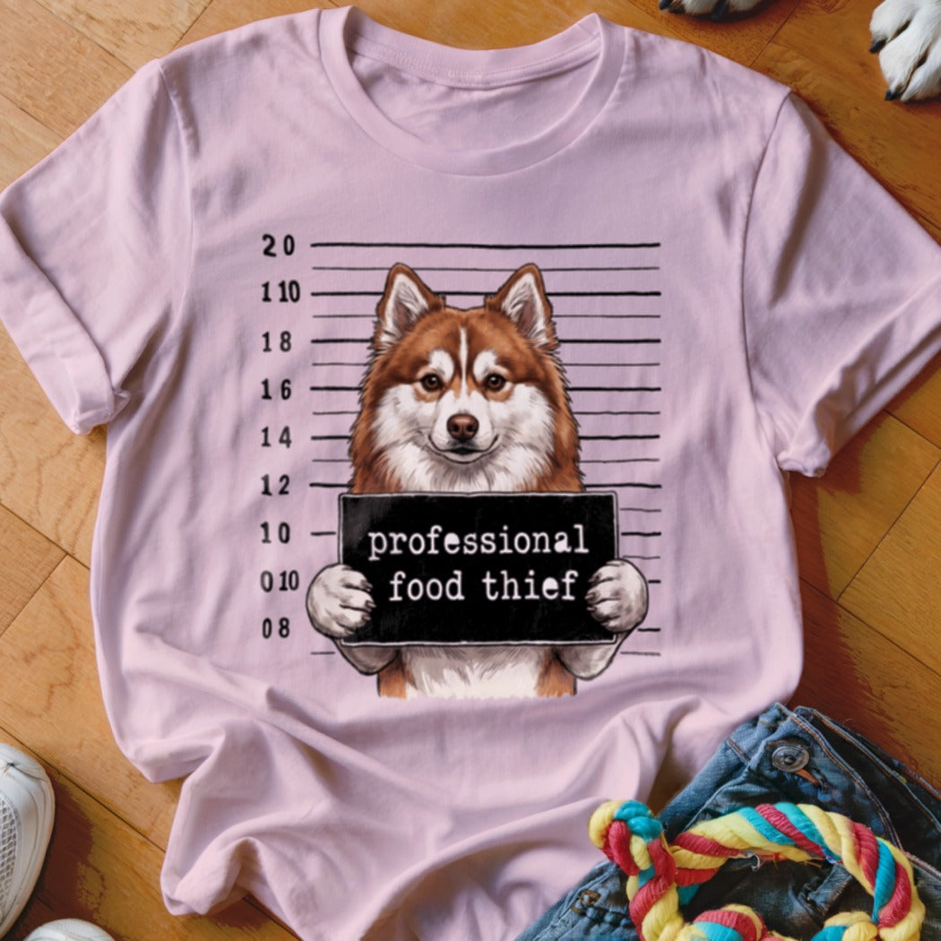 Husky mugshot graphic on a pink t-shirt with text "professional food thief".