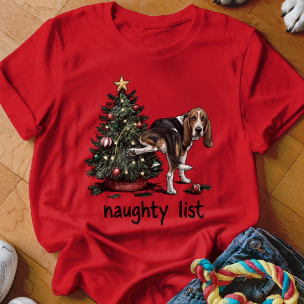 Basset Hound pees on Christmas tree with "naughty list" text.