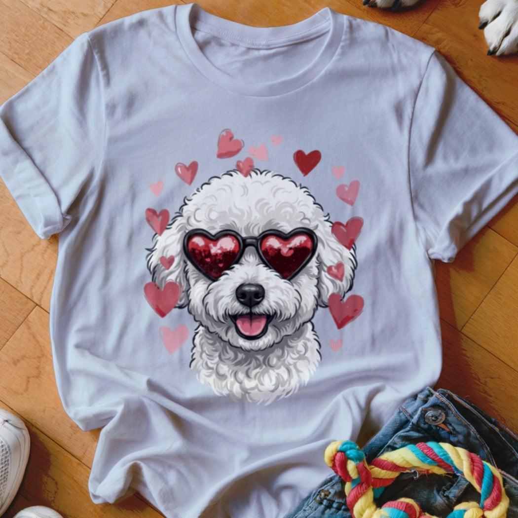 A white t-shirt featuring a graphic of a white poodle wearing heart-shaped sunglasses surrounded by pink hearts.