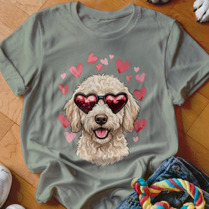 Sage green crewneck t-shirt featuring a graphic of a fluffy golden doodle wearing heart sunglasses surrounded by pink hearts.