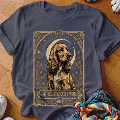 A dark gray t-shirt featuring a tarot card graphic with an English Cocker Spaniel.