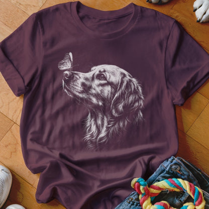 Maroon short-sleeved t-shirt featuring a white line drawing of a golden retriever looking at a butterfly.