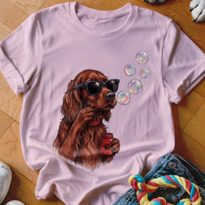 A light pink t-shirt features a graphic of an Irish Setter wearing sunglasses and blowing soap bubbles.