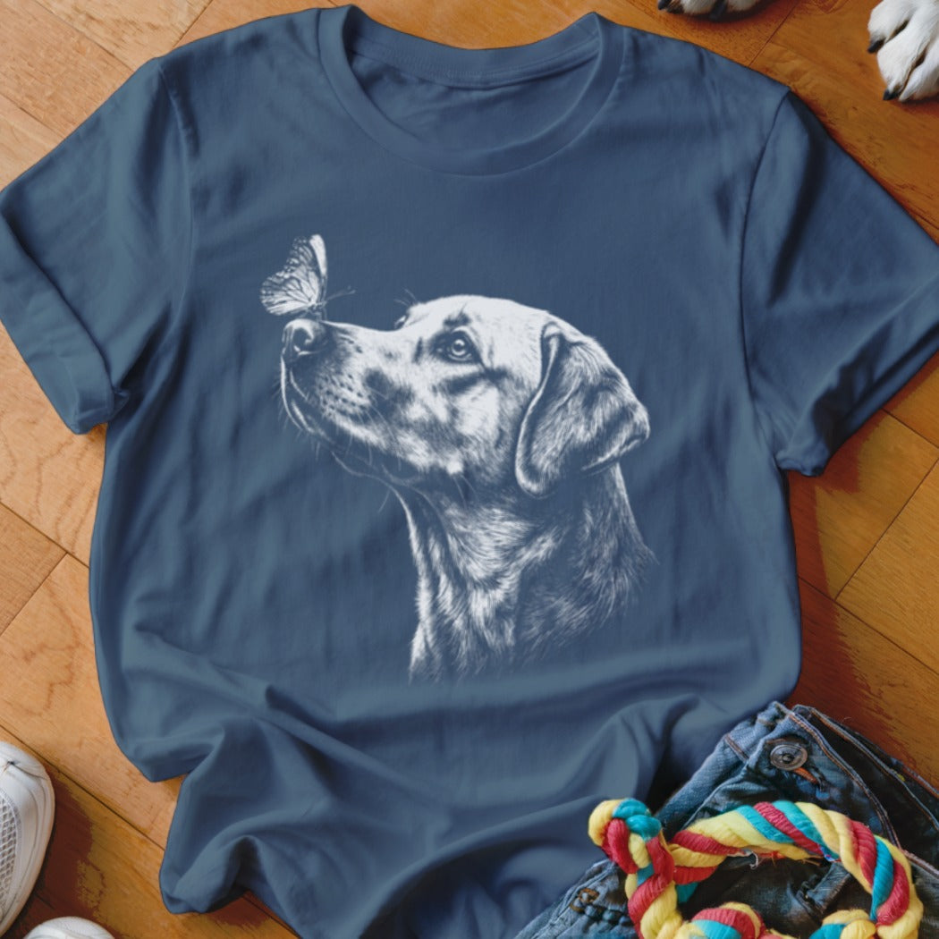 Dark blue crewneck t-shirt featuring a white sketch graphic of a dog looking at a butterfly on its nose.