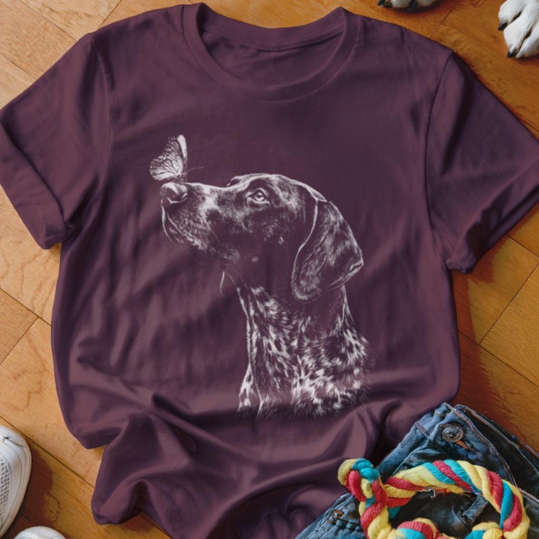 Maroon crewneck t-shirt featuring a white line drawing of a German Shorthaired Pointer looking at a butterfly.