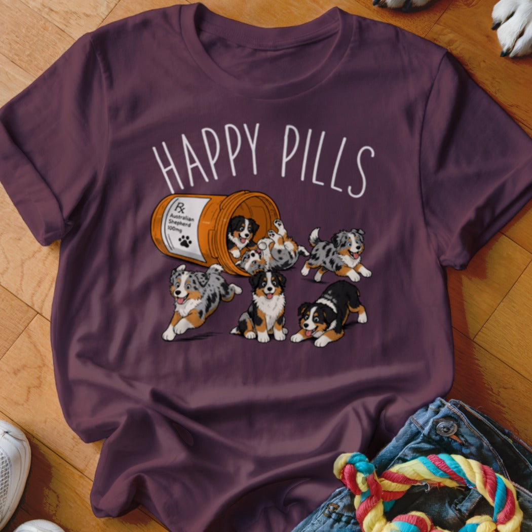 T-shirt with "Happy Pills" text and Australian Shepherd puppies spilling from a pill bottle.