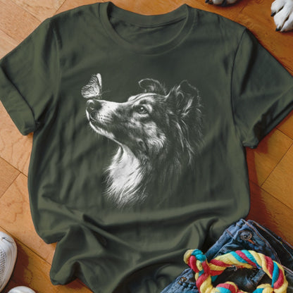 Dark green t-shirt featuring a white line drawing of a Collie dog looking at a butterfly on its nose.