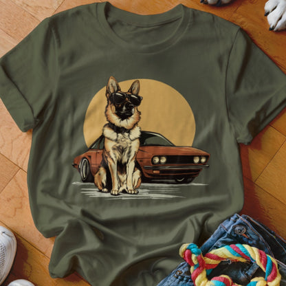 German Shepherd wearing sunglasses sitting next to a vintage car with a large sun.