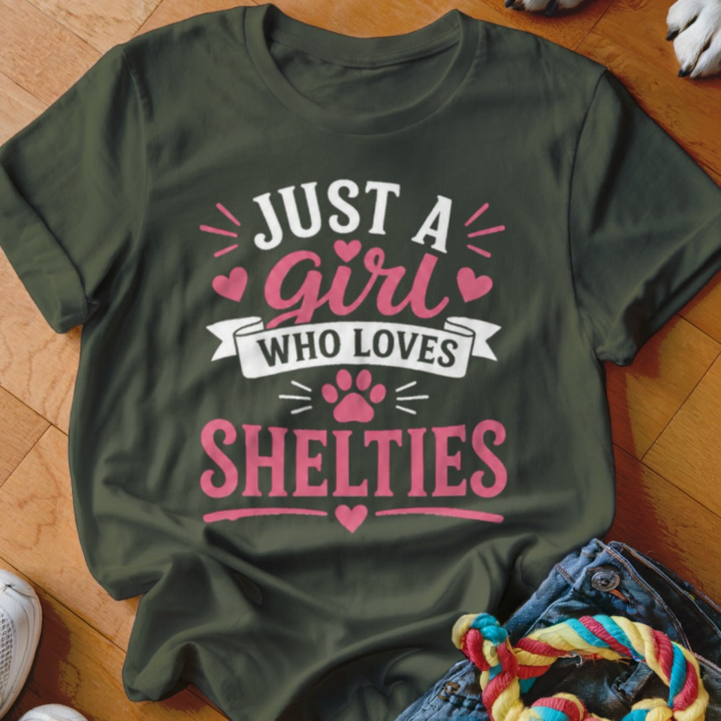 Green t-shirt with pink text "Just a girl who loves Shelties" and paw print.