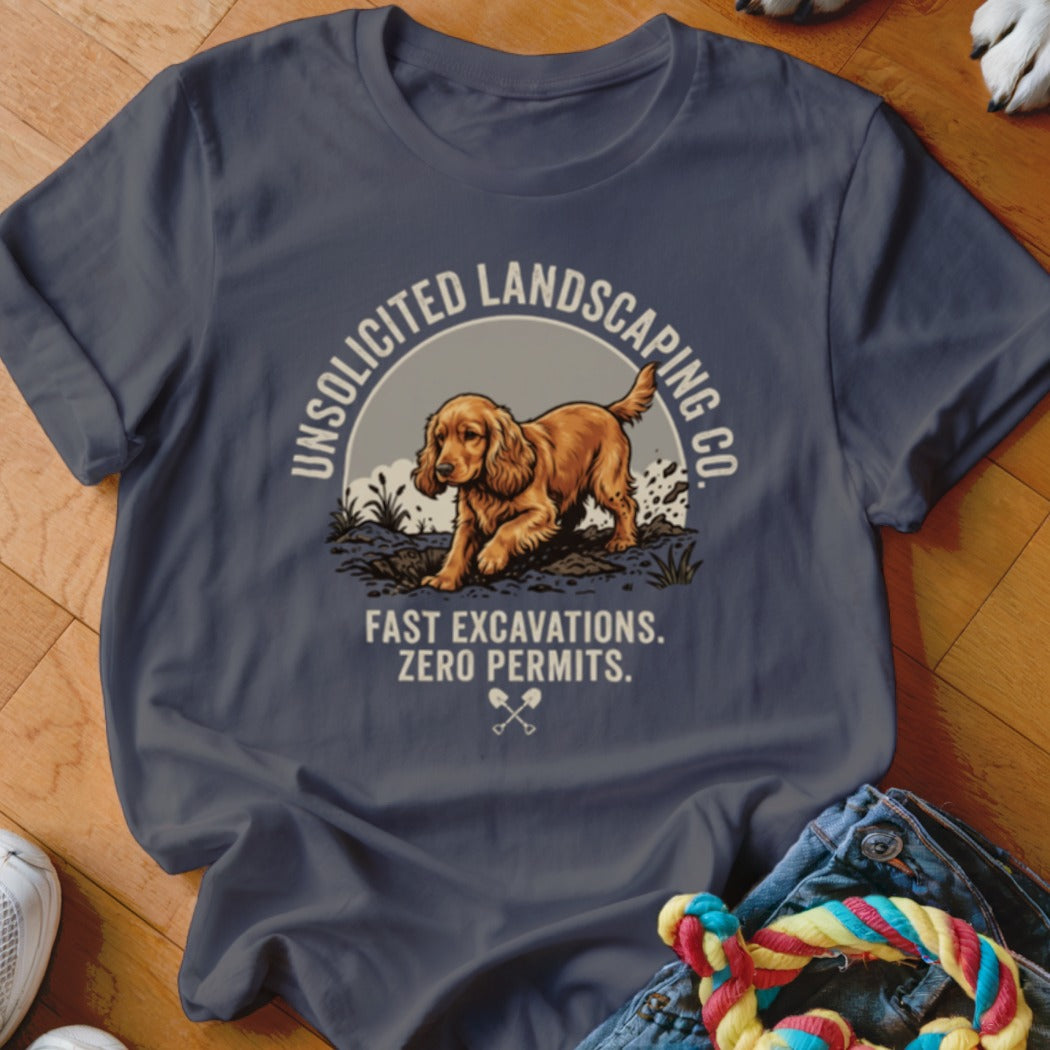 Dark grey t-shirt with a golden dog digging, "Unsolicited Landscaping Co.", and "Fast Excavations. Zero Permits."
