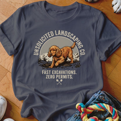 Dark grey t-shirt with a golden dog digging, "Unsolicited Landscaping Co.", and "Fast Excavations. Zero Permits."