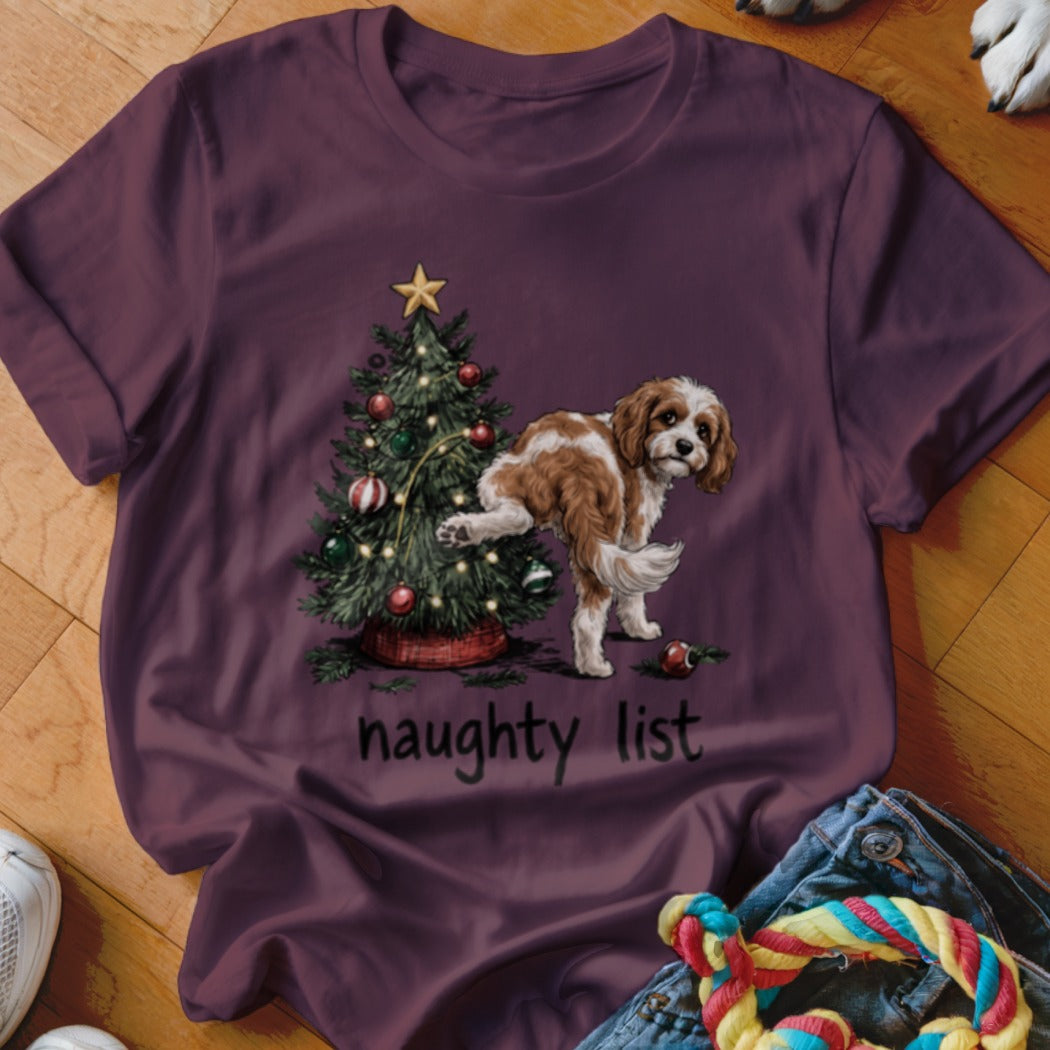 Dog lifting leg on Christmas tree with "naughty list" text.