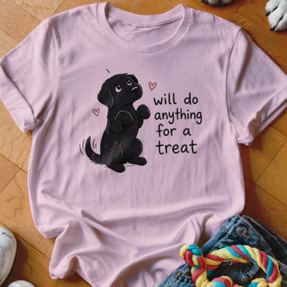 Pink t-shirt with a black dog illustration and the text "will do anything for a treat".
