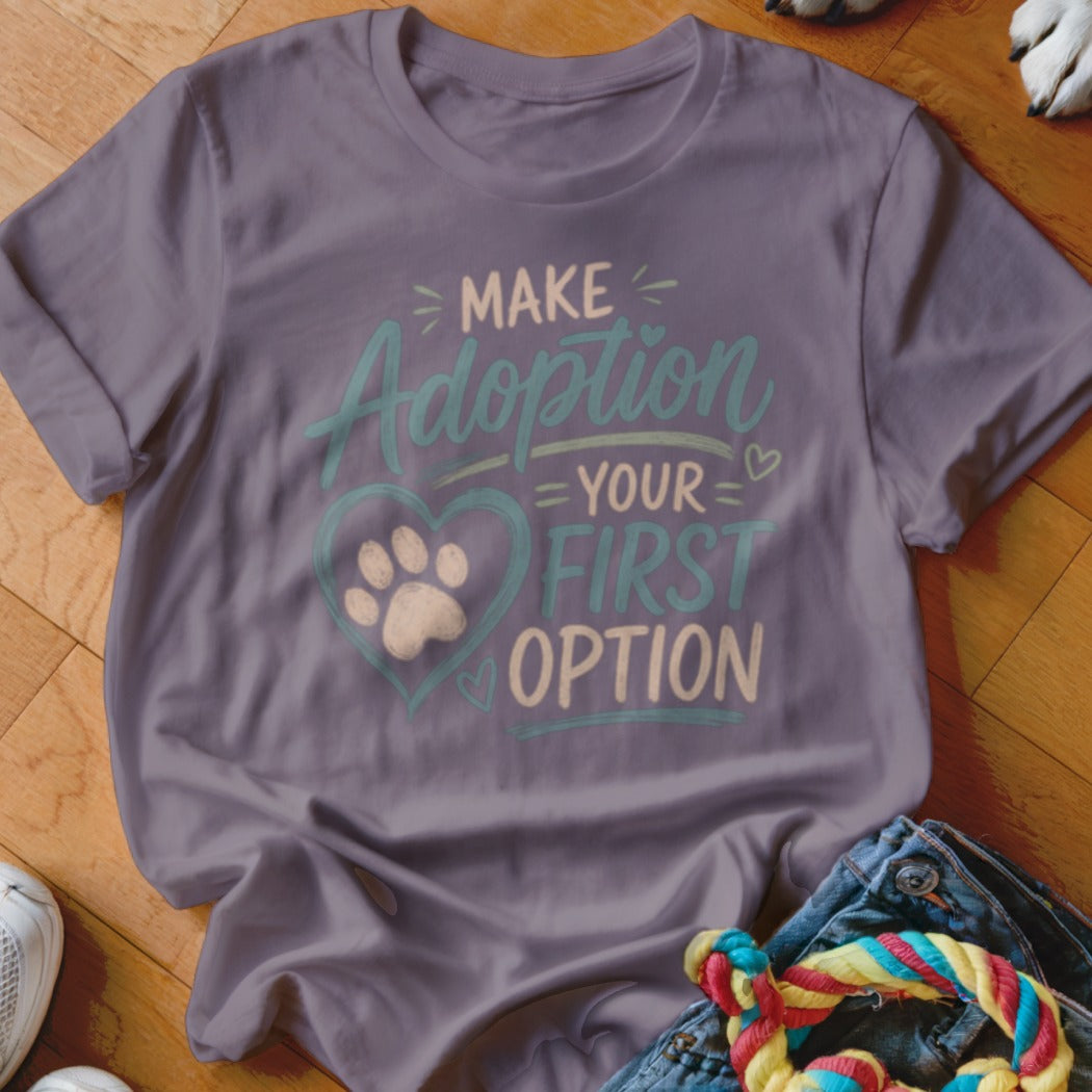 Purple t-shirt with "Make Adoption Your First Option" text and paw print heart graphic.
