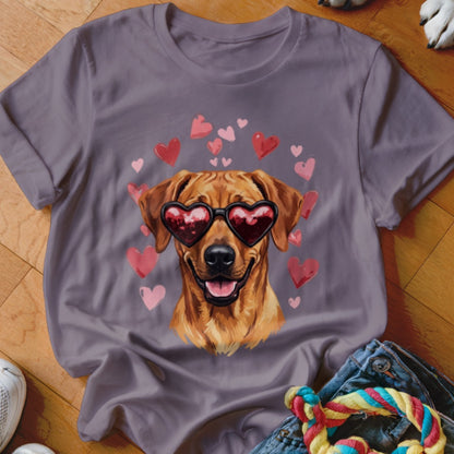 A grey t-shirt features a graphic of a golden dog wearing heart-shaped sunglasses, surrounded by pink hearts.