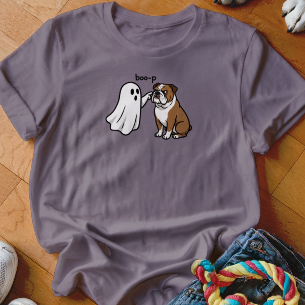 Ghost "boop-ing" a seated English Bulldog on a purple t-shirt.