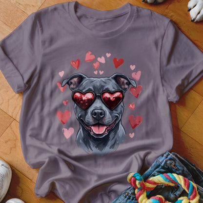 Grey t-shirt featuring an illustration of a black dog wearing heart-shaped sunglasses surrounded by pink hearts.