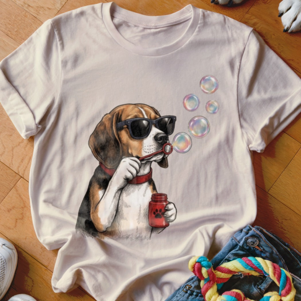 Light beige crewneck t-shirt featuring a graphic of a beagle wearing sunglasses and blowing soap bubbles.