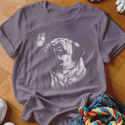 A mauve t-shirt features a white sketch of a pug looking at a butterfly on its nose.